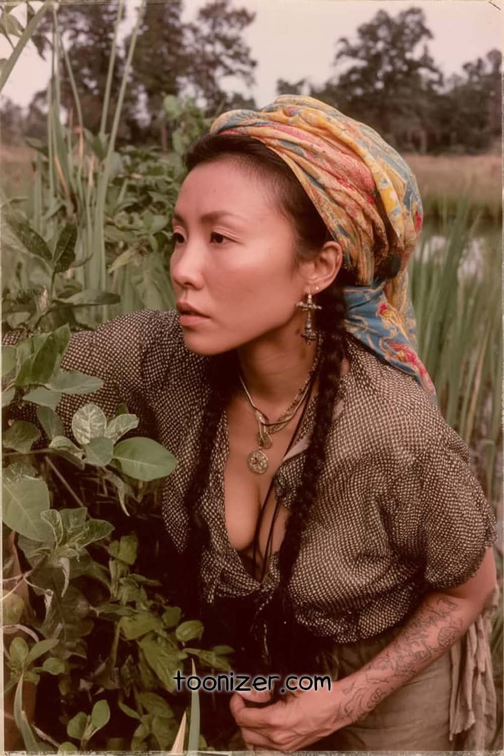 Person wearing colorful headscarf in nature.