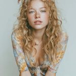 Woman with curly hair wearing patterned dress