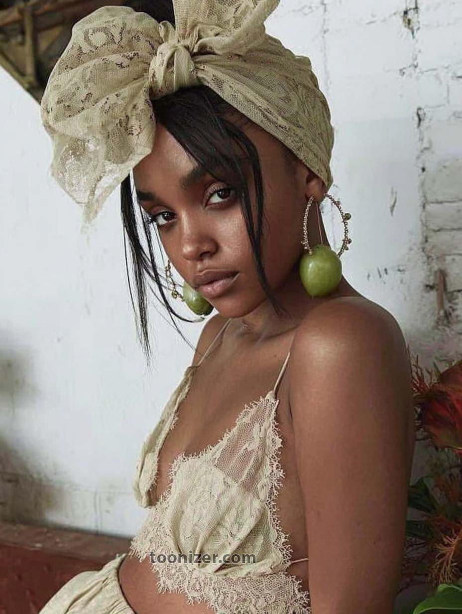 Woman in lace headscarf with apple earrings.