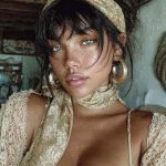 Woman wearing lace outfit with headscarf.