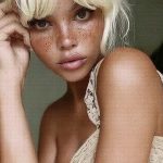 Stylized portrait of person with freckles and blonde hair.