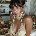 Woman in lace outfit near table with food