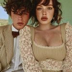 Two people posing in vintage-style outfits.