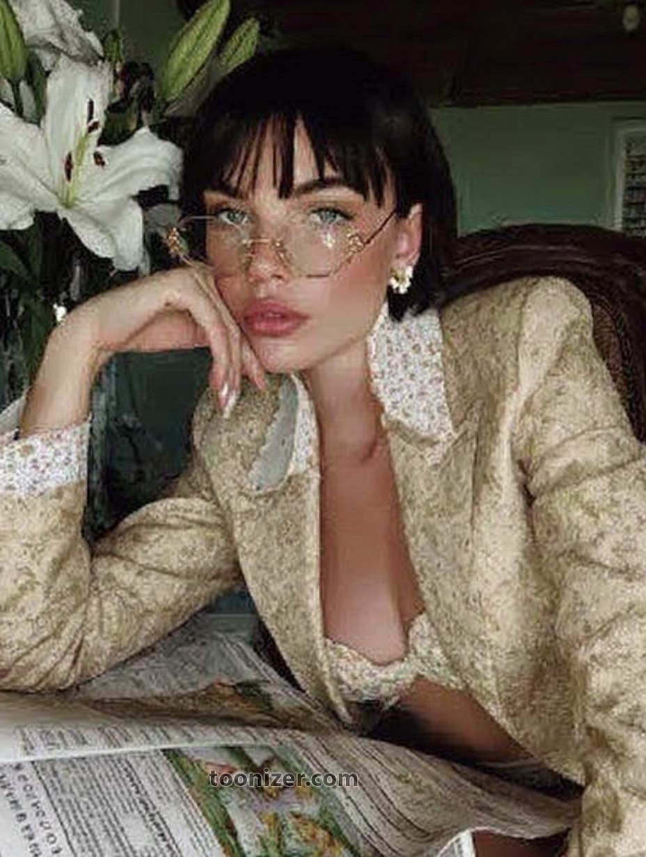 Elegant woman reading newspaper with flowers nearby.