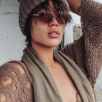 Person wearing knit hat and sunglasses