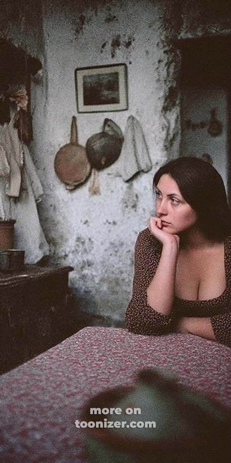Woman sitting in rustic room, contemplating.
