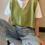 Casual outfit with green sweater vest.