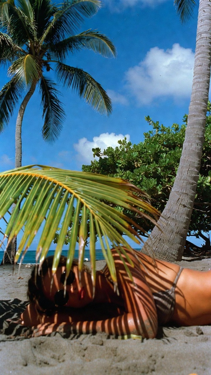 Person sunbathing on tropical beach