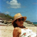Person relaxing on a sunny beach.