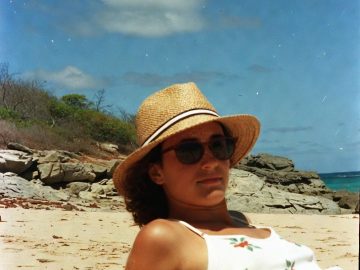 Person relaxing on a sunny beach.