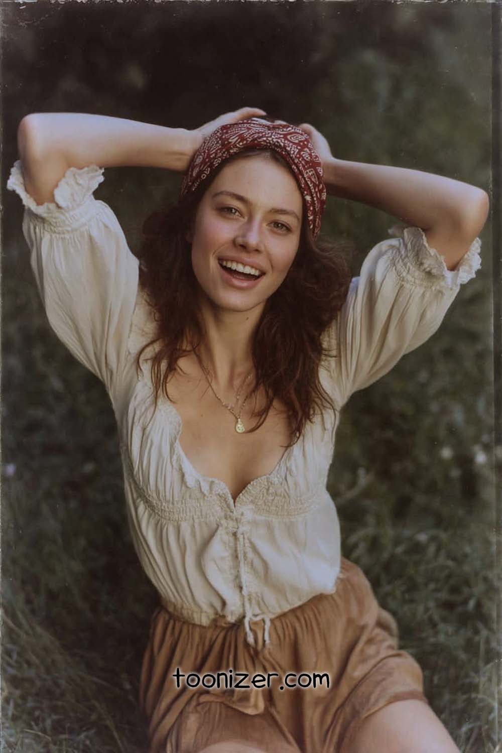 Smiling woman with hands on head outdoors