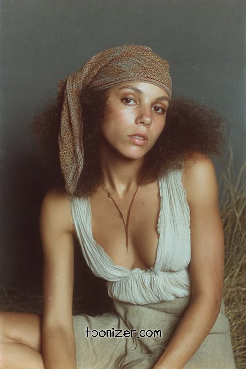 Woman in headscarf with textured hair.