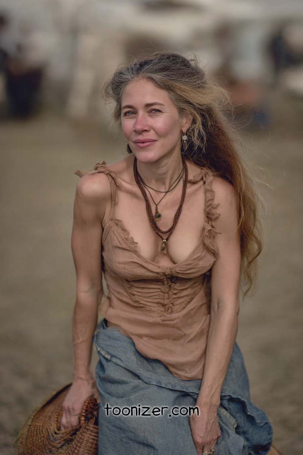 Woman in rustic clothing sitting outdoors