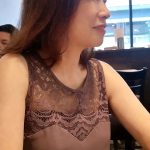 Woman in lace top at a cafe