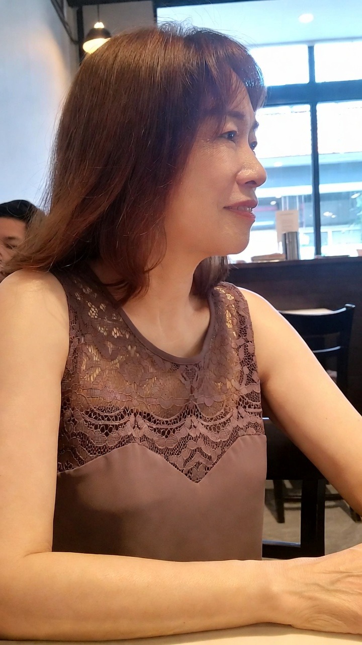 Woman in lace top at a cafe