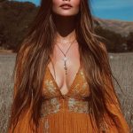 Woman in orange dress in a field