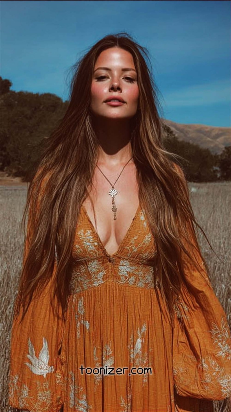 Woman in orange dress in a field