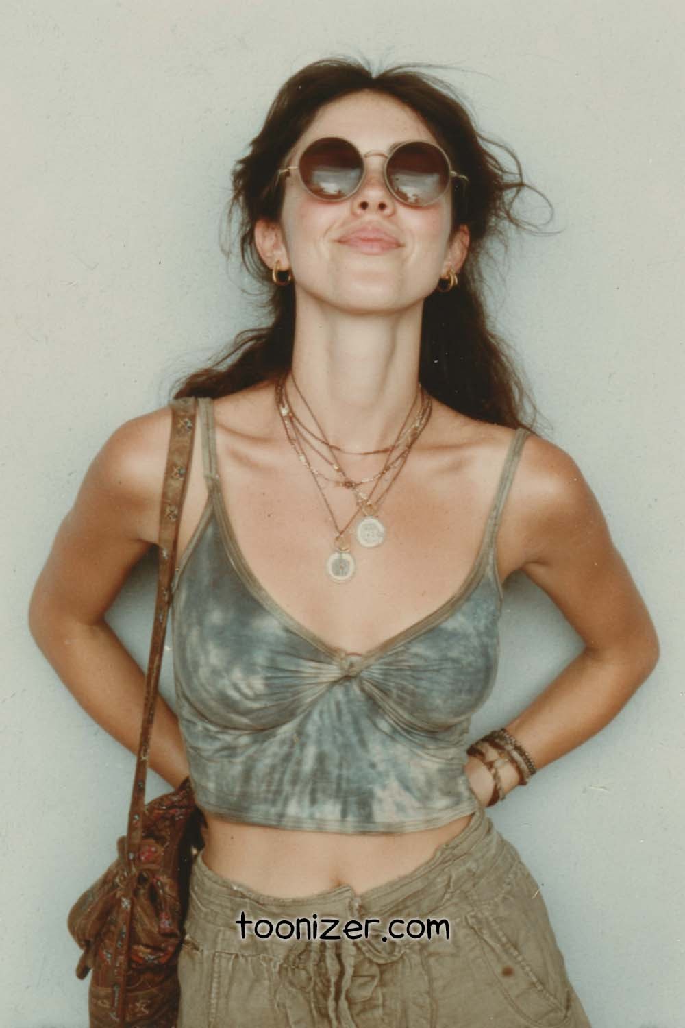 Woman in sunglasses and casual outfit.