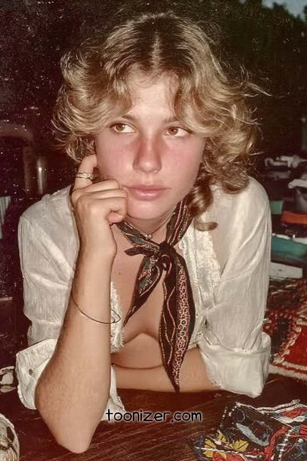 Young person with curly hair and scarf