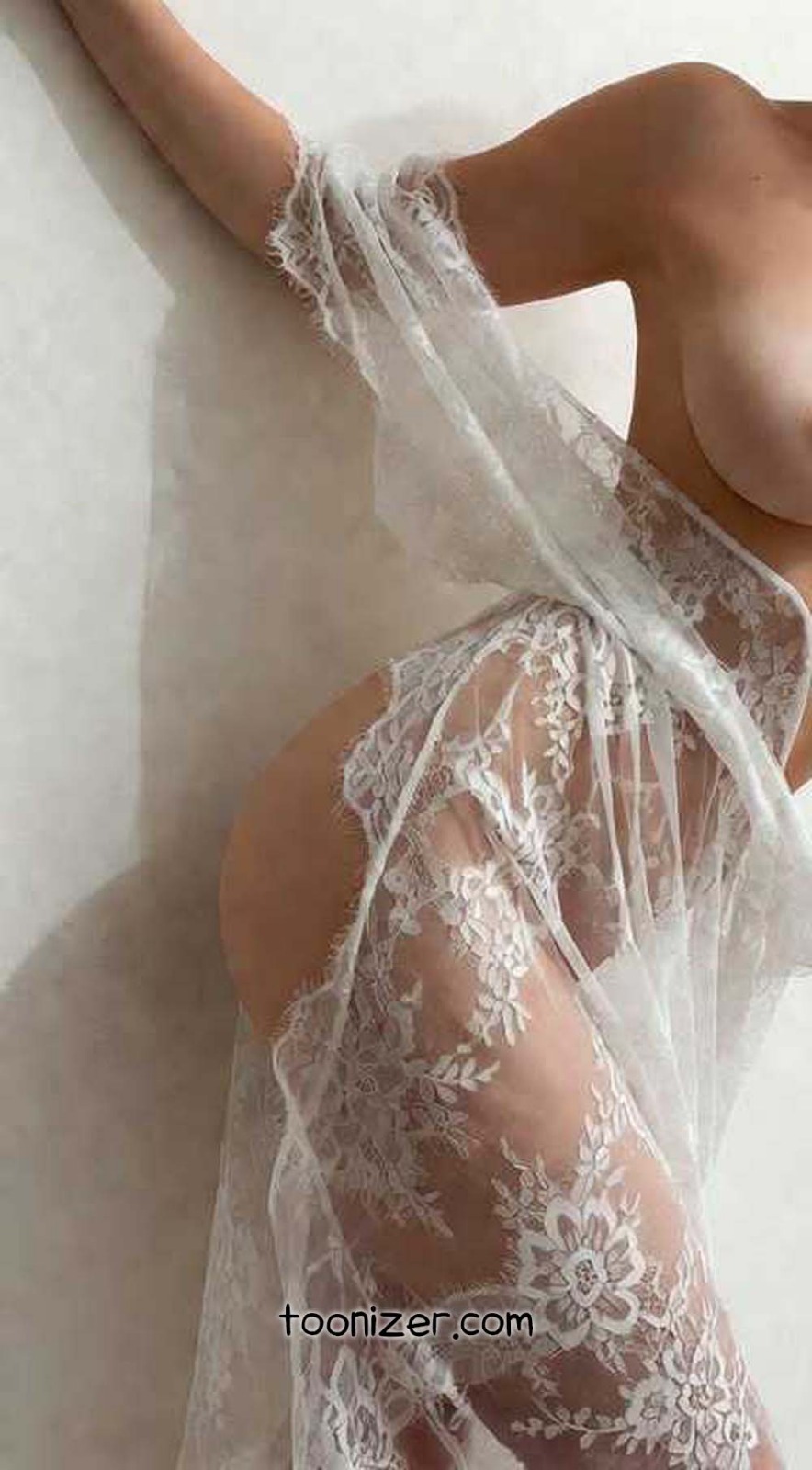 Person draped in floral lace fabric