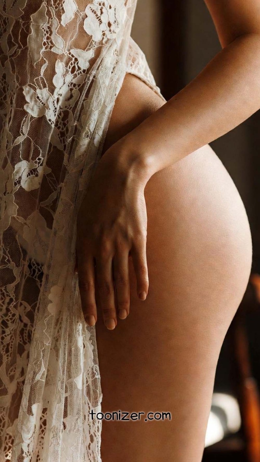 Close-up of hand on lace fabric