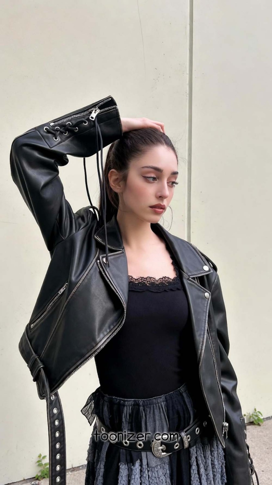 Woman in black leather jacket posing