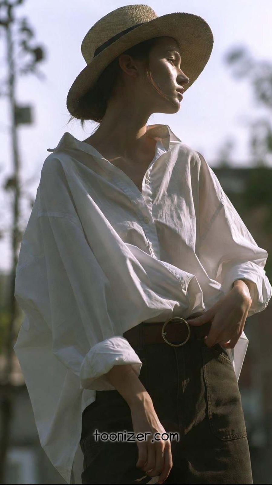 Person in hat and white shirt outdoors