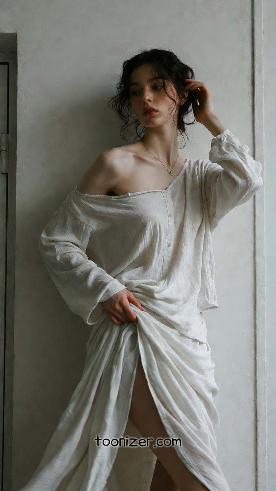 Woman in off-shoulder white dress posing.