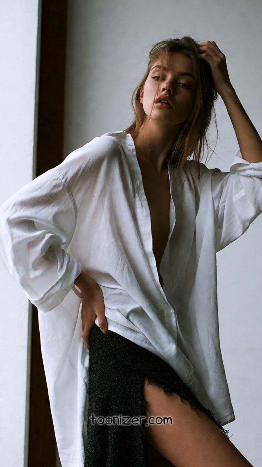 Woman posing in oversized white shirt