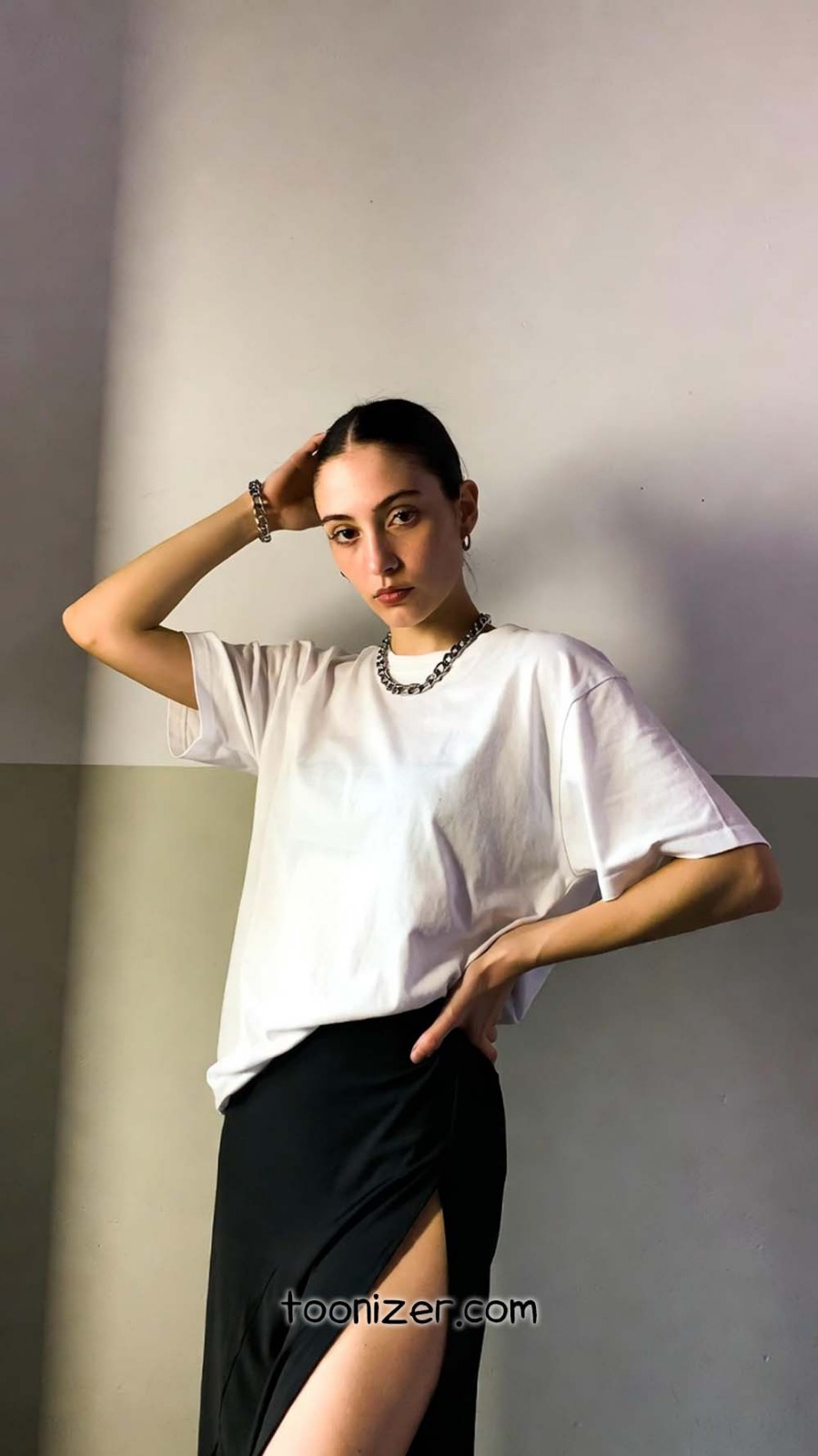 Woman in white shirt and black skirt.