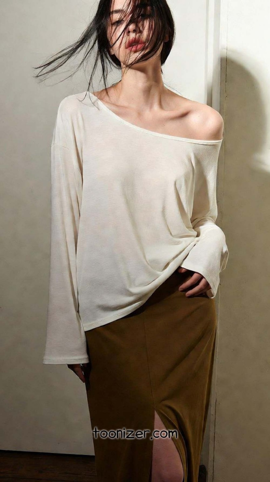 Woman posing in white top and brown skirt