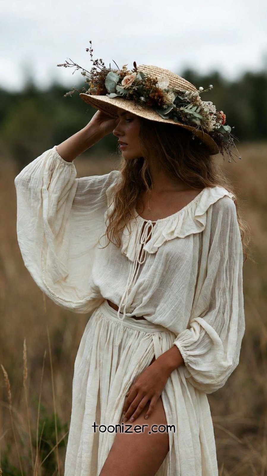 Woman in a white dress with floral hat