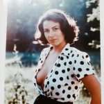 Woman in polka dot blouse outdoors portrait