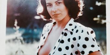 Woman in polka dot blouse outdoors portrait