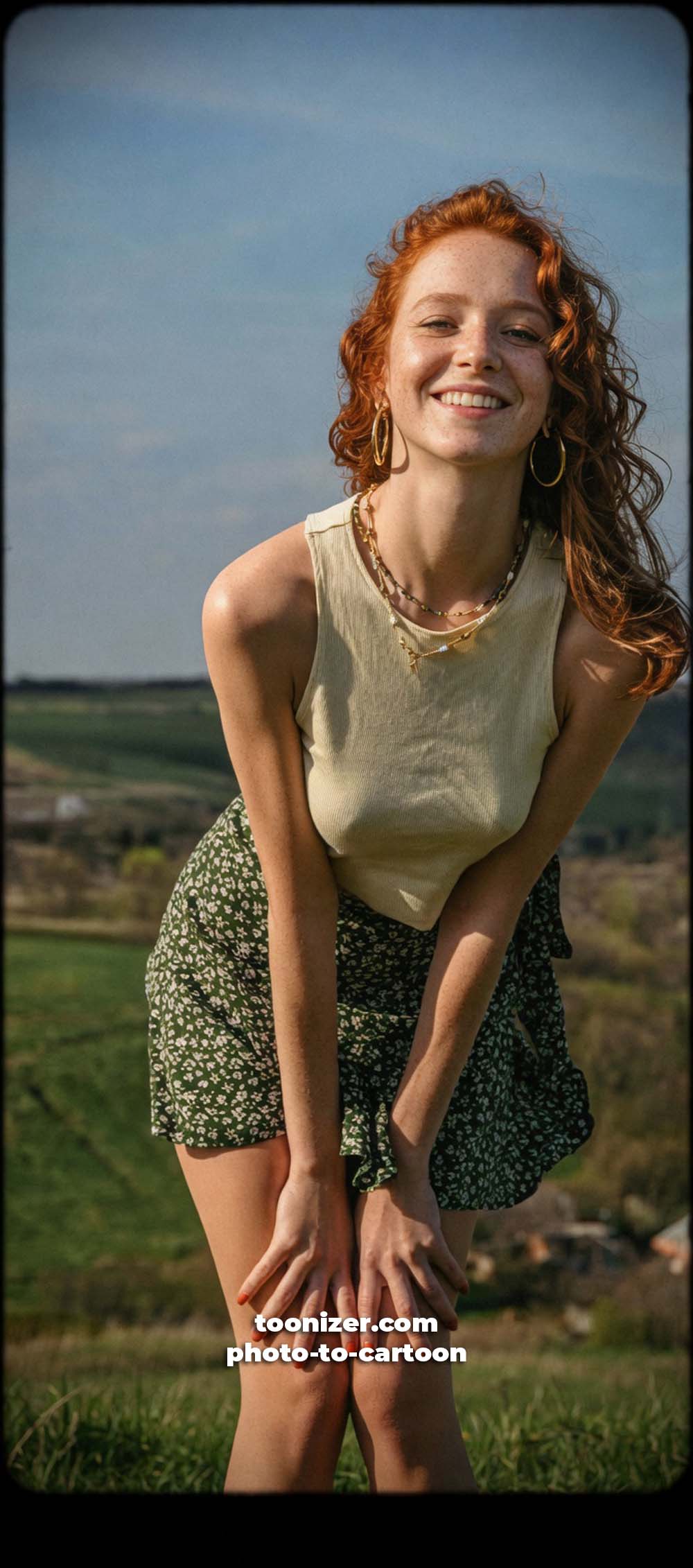 Smiling red-haired woman posing outdoors on hillside