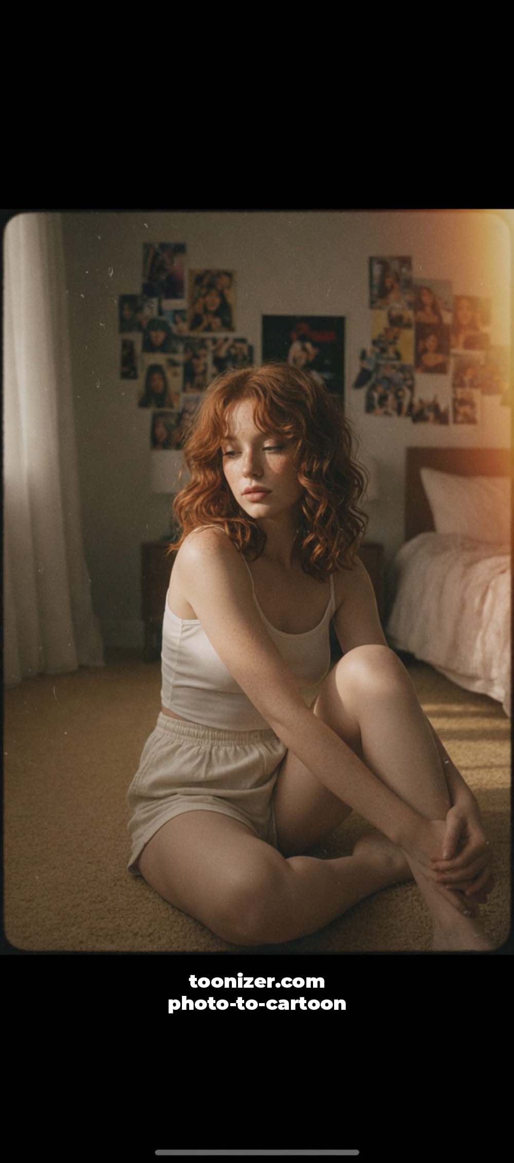 Red-haired woman sitting on bedroom floor in sunlight