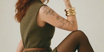 Woman with red hair in green dress posing