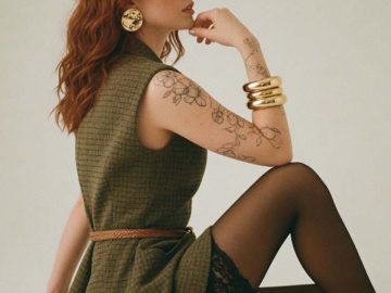 Woman with red hair in green dress posing