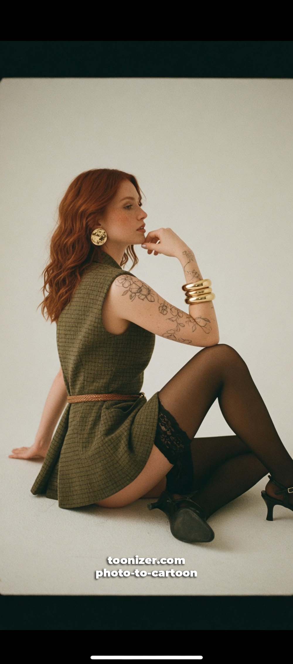 Woman with red hair in green dress posing