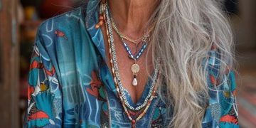 Woman with long gray hair wearing bohemian jewelry