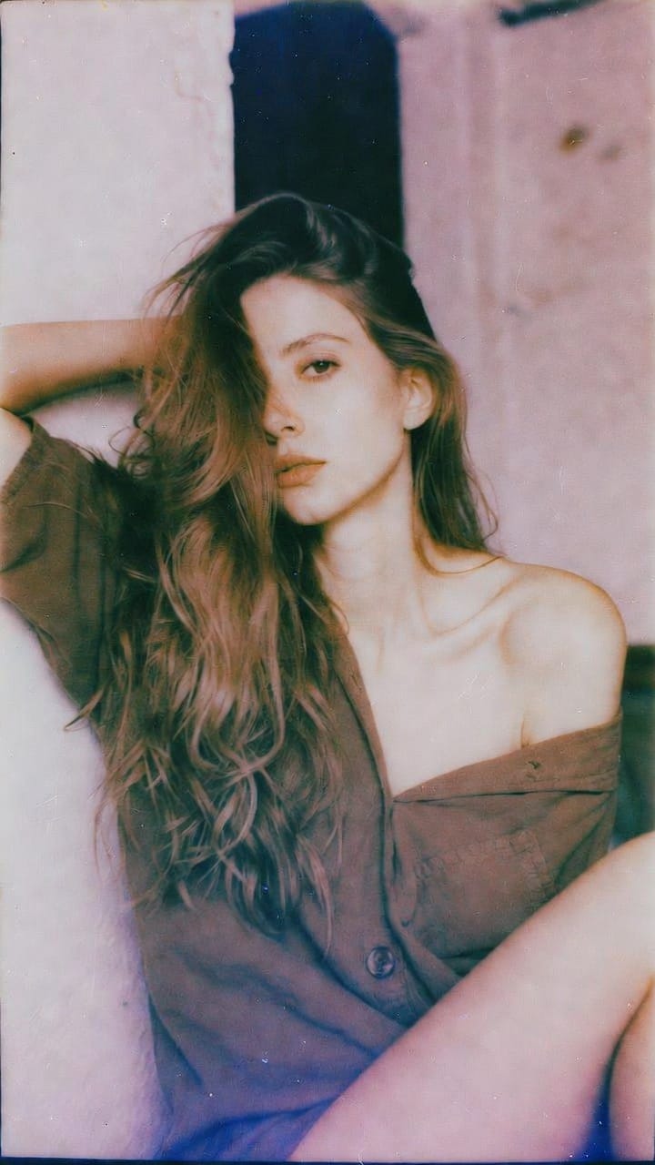Woman with long hair in off-shoulder shirt