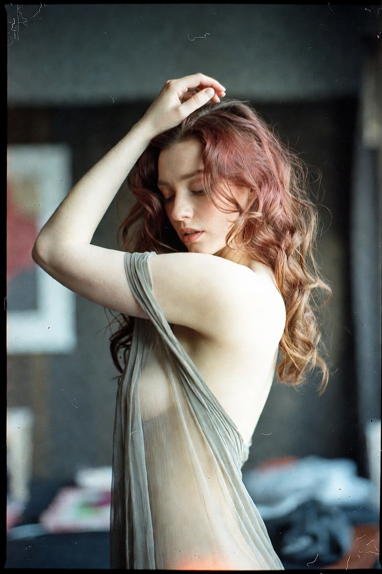 Woman in sheer dress posing indoors