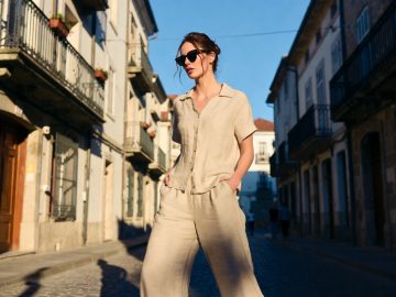 Woman in beige outfit walking European street