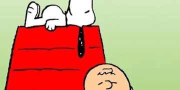 Snoopy on doghouse with Charlie Brown smiling