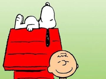 Snoopy on doghouse with Charlie Brown smiling