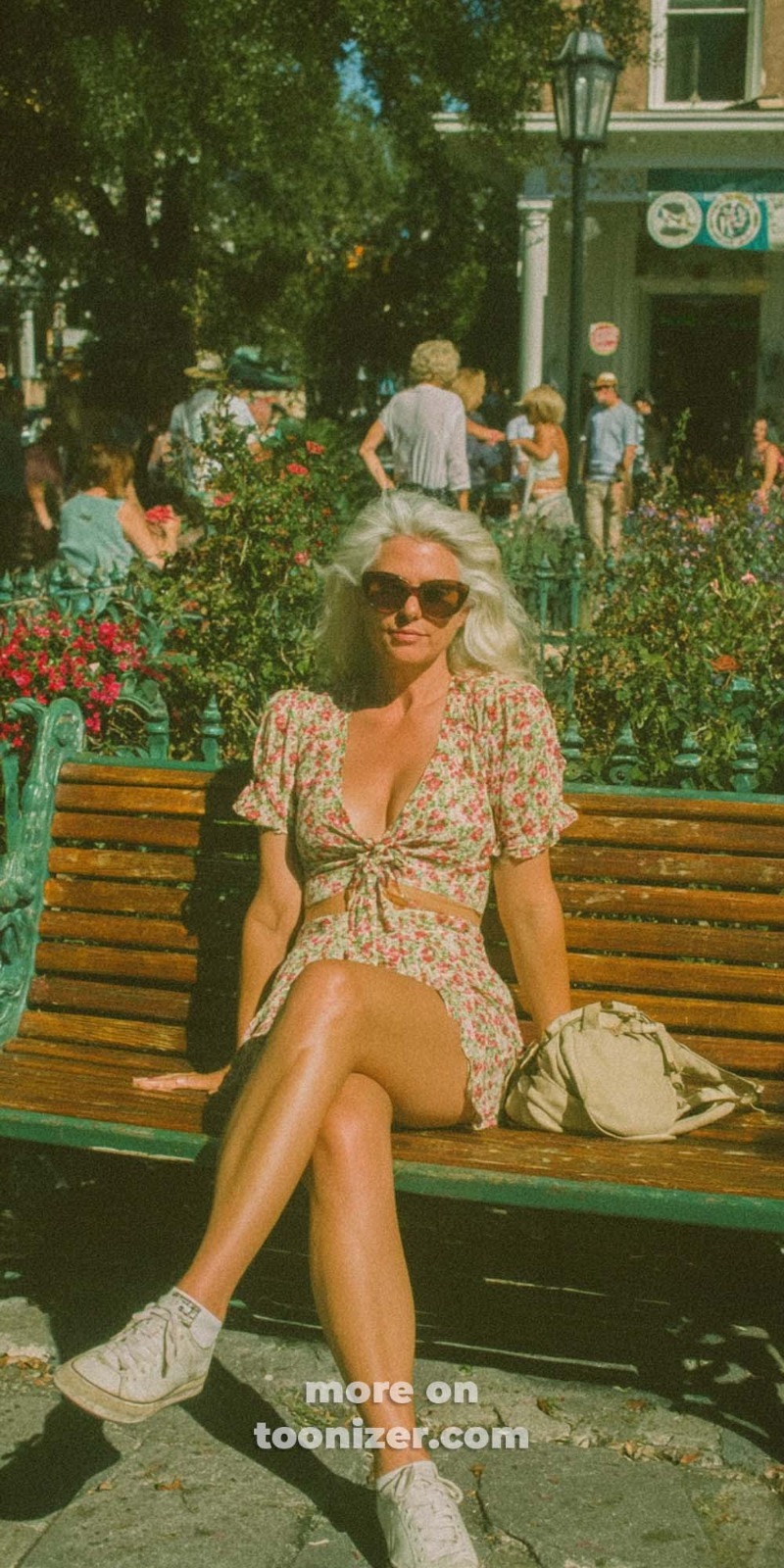 Woman in floral dress sitting on park bench