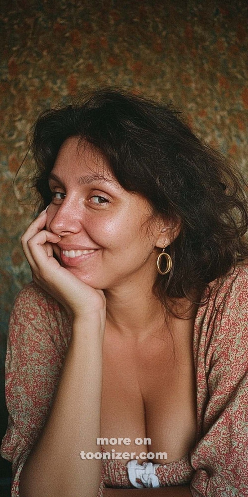 Smiling woman with dark hair resting on hand