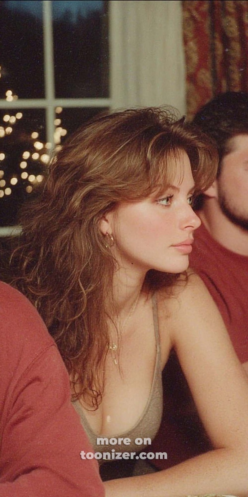 Woman with wavy hair in warm indoor setting