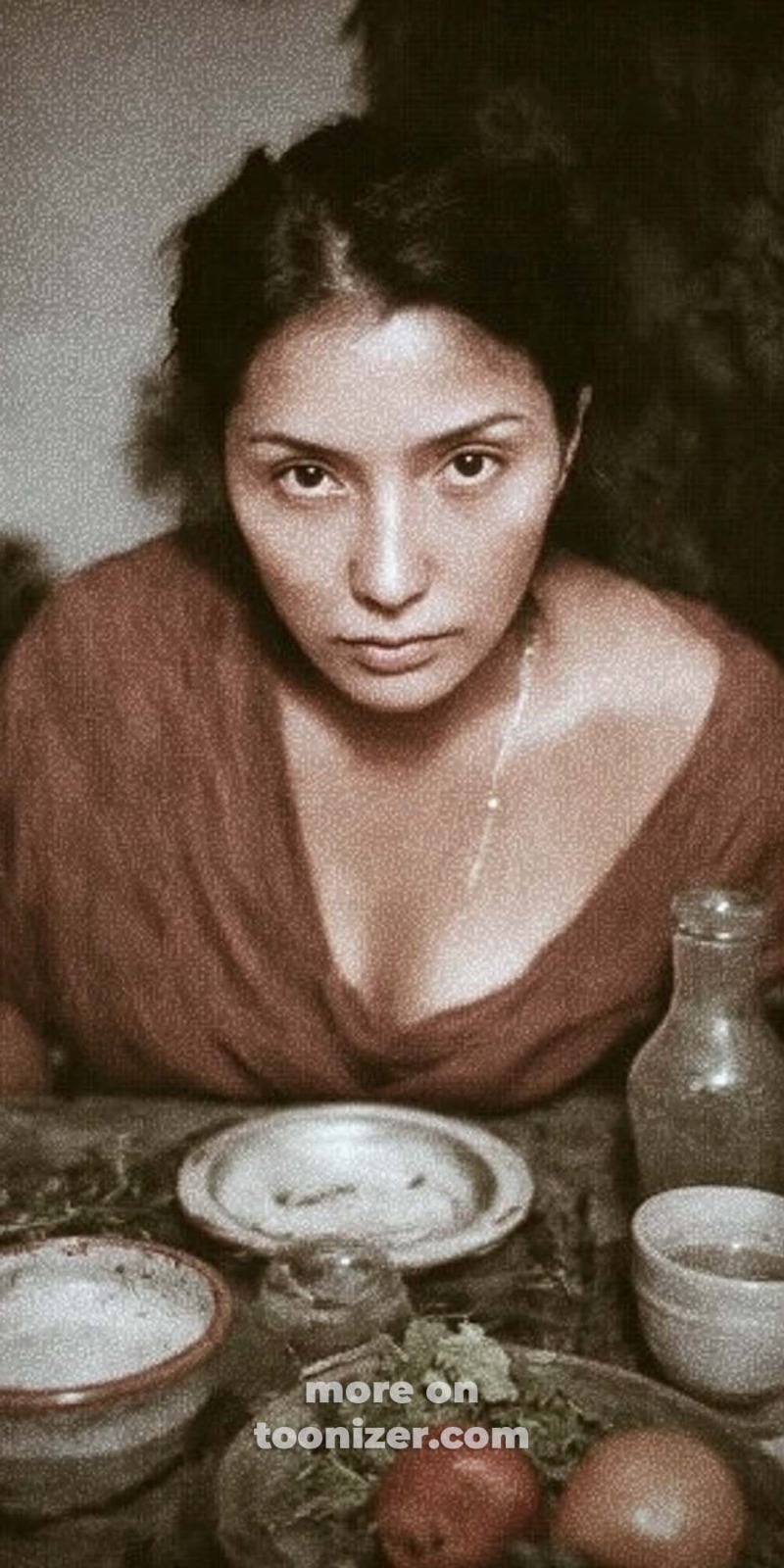 Woman staring intensely at table with simple meal