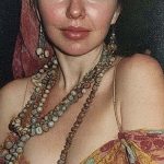 Woman wearing headscarf and layered beaded necklaces